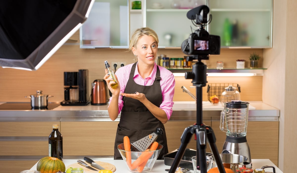 Woman producing a cooking video in her kitchen