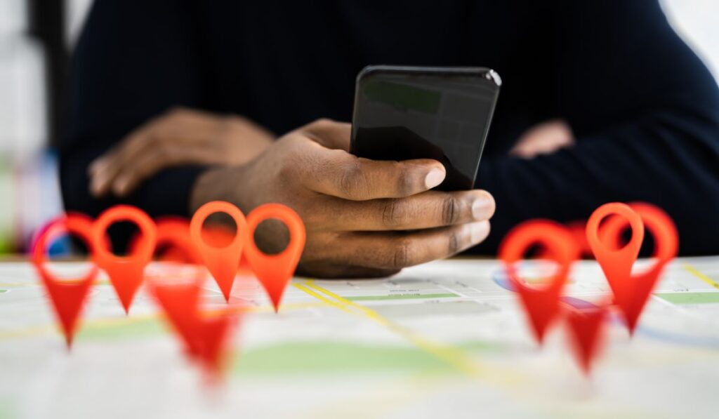 Canva-Zen 9 Marketing GMB SEO Services person holding a cell phone with map pins in the foreground representing local search