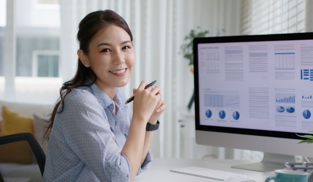 Canva-Zen 9 Marketing Professional SEO Directories young woman at her desk looking over website analytics