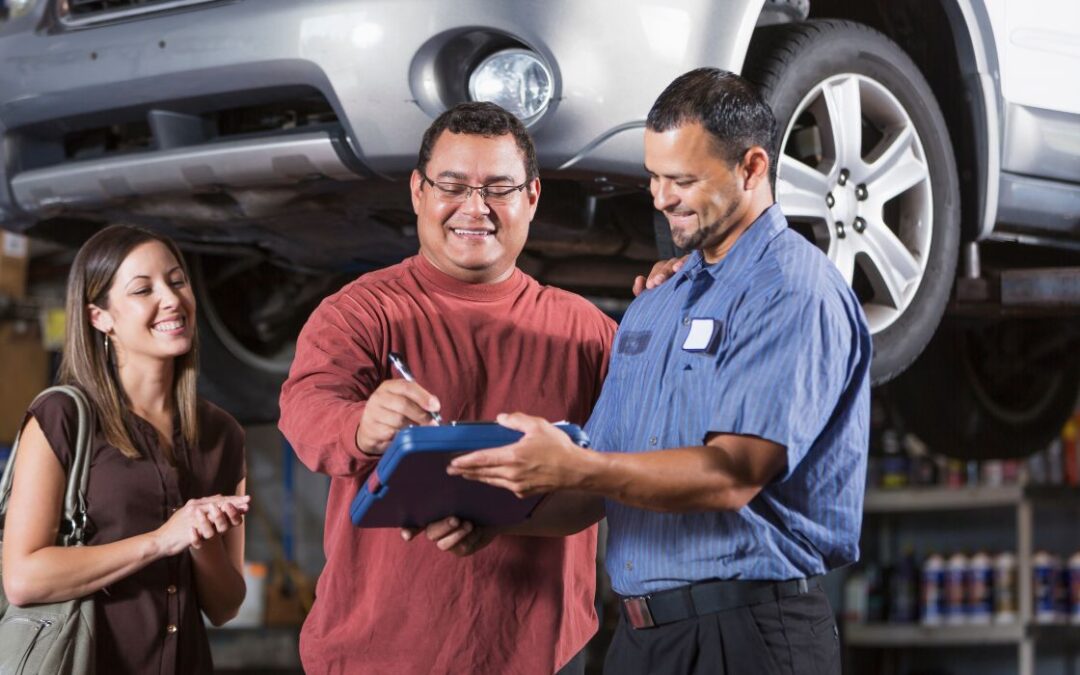 Canva-Zen 9 Marketing auto repair shop SEO mechanic going over a contract to fix a vehicle with two customers