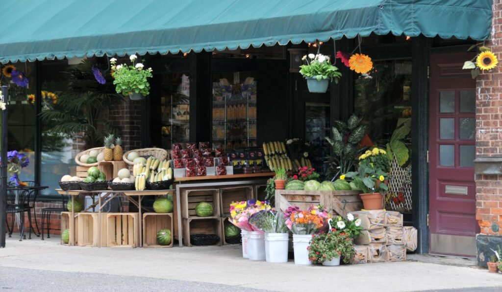 Canva-Zen 9 Marketing Small local shop with produce and flowers out front