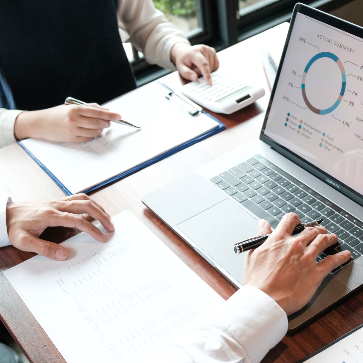 Canva-Zen 9 Marketing Square Two people at a desk going over analytics on a laptop