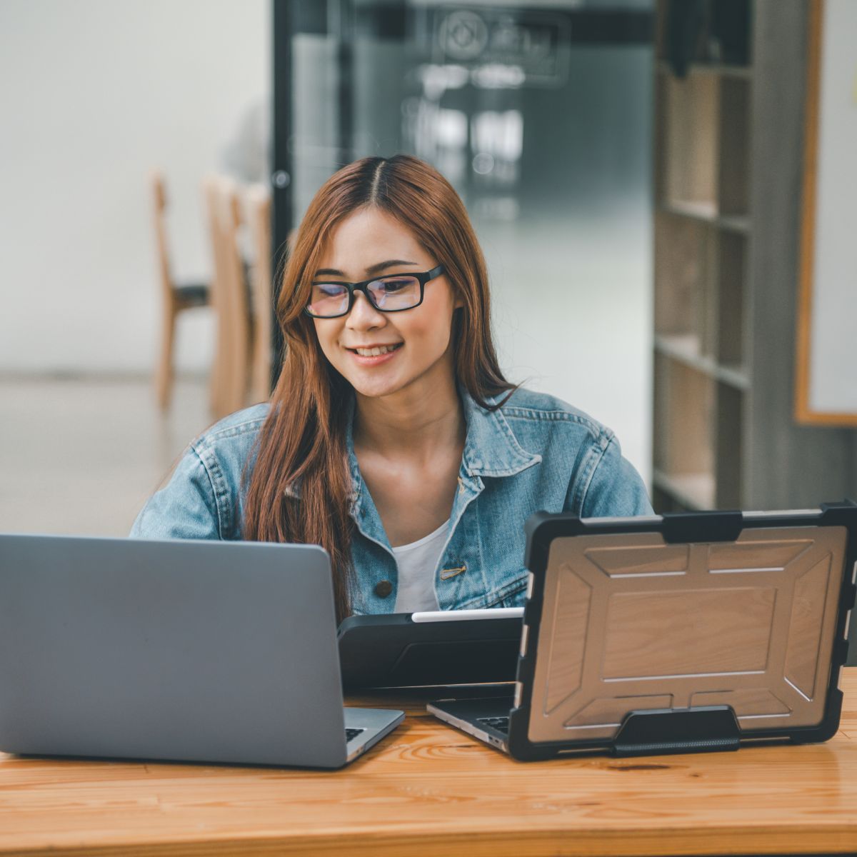 Canva-Zen 9 Marketing Website Optimizatiion Case Study woman in front of two laptops and an ipad optimizing a website