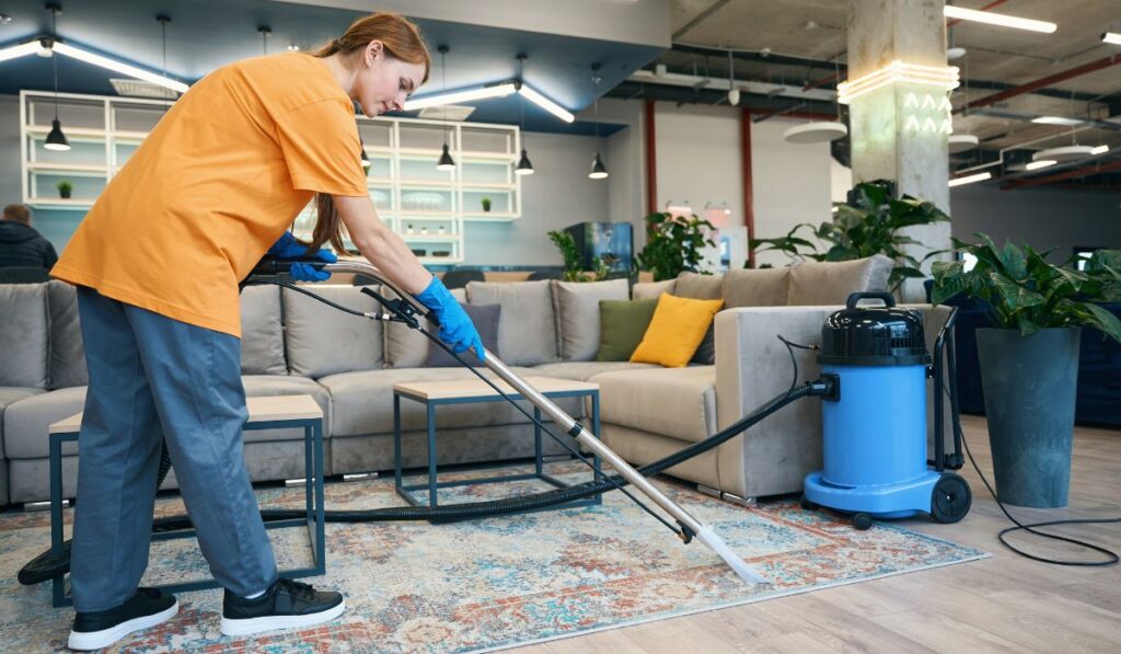 Canva-Zen 9 Marketing woman using a carpet cleaner on a rug