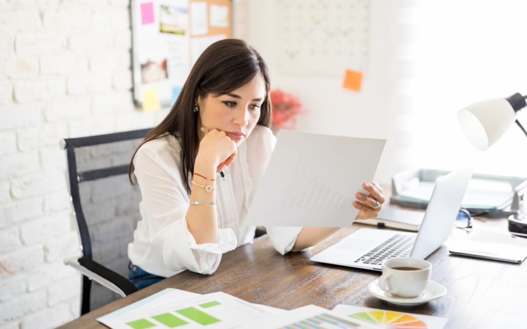 woman reviewing a document at her desk