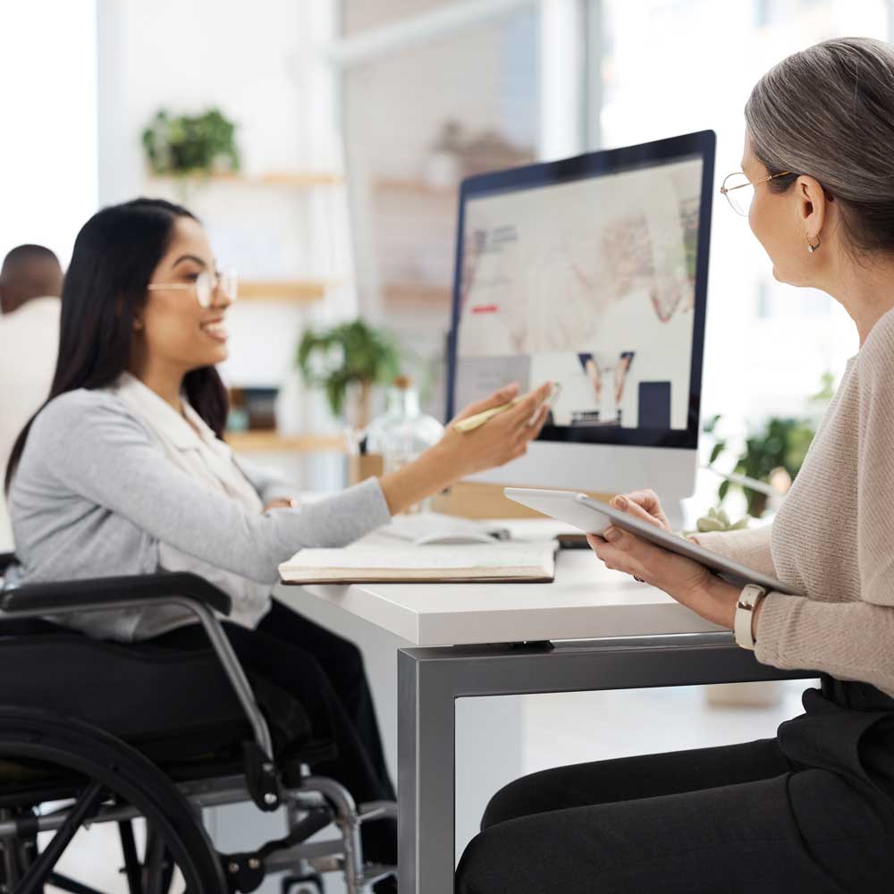 Young disabled businesswoman getting some information from her human resources manager in the office